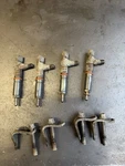 Kubota V2203 Di Fuel Injectors With Hold Down Clamps And Hardware. Fixed Price $145.00.